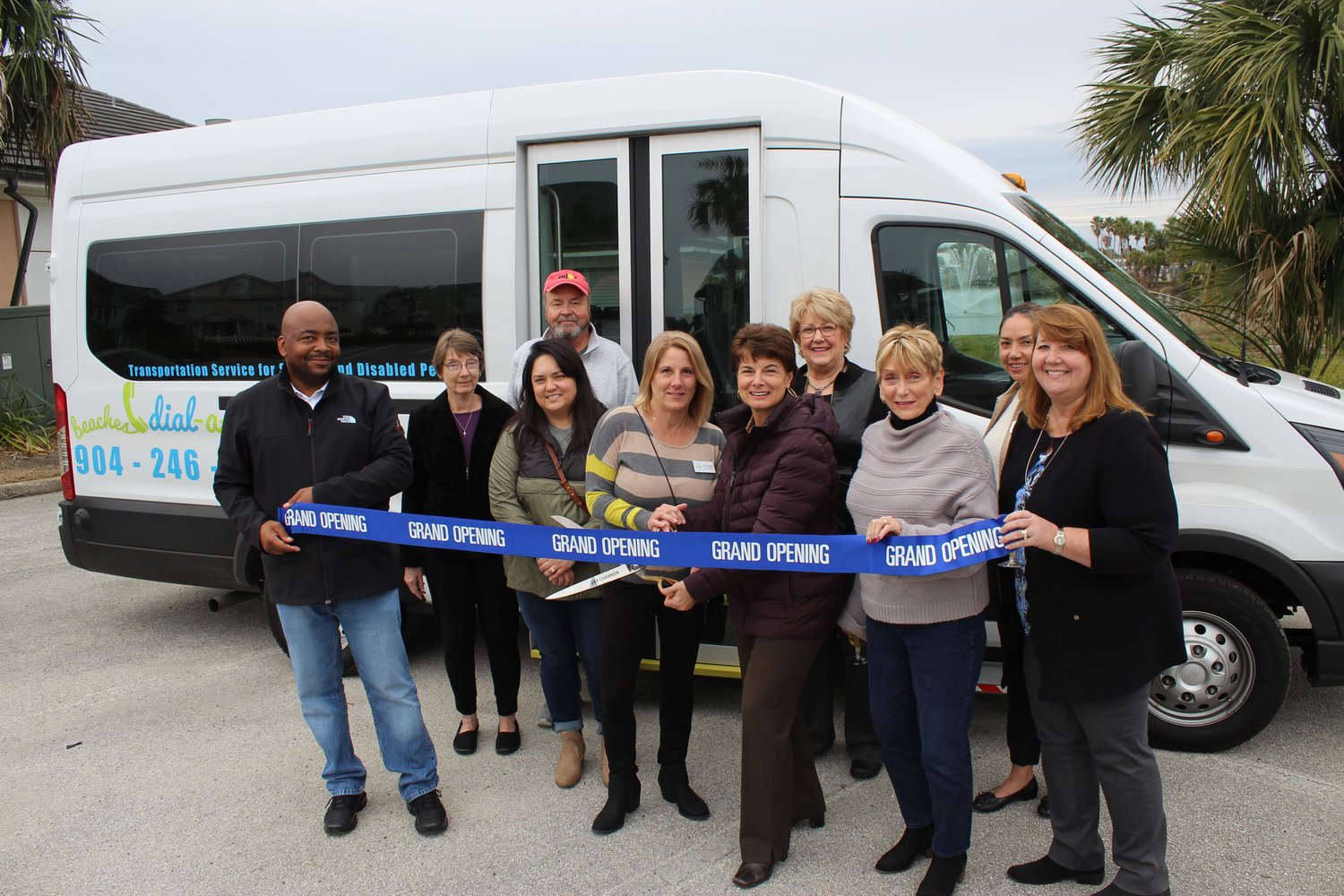 Beaches Council on Aging staff and board, including President Vicki Wyckoff and Executive Director Lori Anderson, with the scissors, are seen next to Neptune Beach Mayor Elaine Brown.